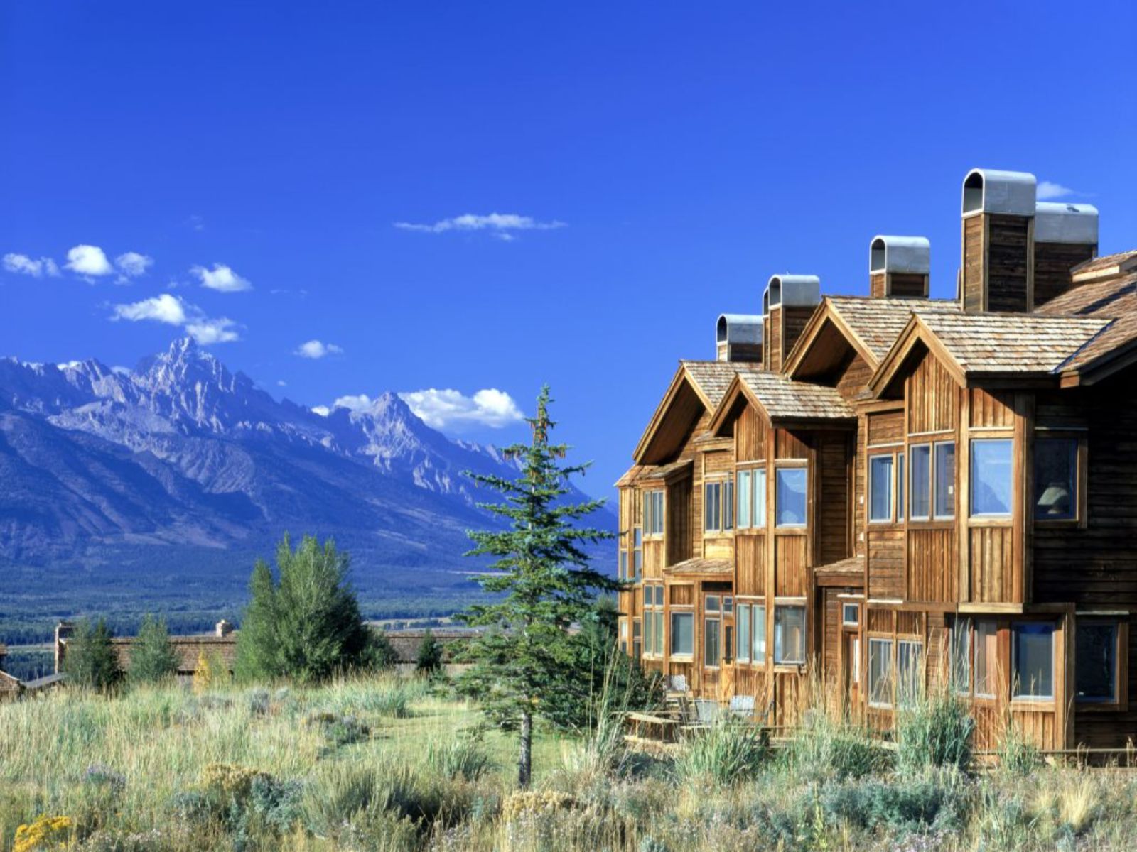 Rondreis Amerika, Grand Teton NP, Spring Creek Ranch, buitenkant hotel met bergen